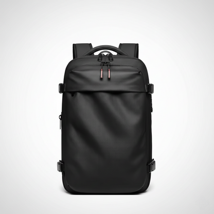 A professional, centered studio shot of a matte black travel backpack or commuter backpack against a white-to-grey gradient background. The rectangular bag features a water-resistant or durable textured shell, padded shoulder straps, a top handle, and zipper pulls with red accents. Side compression straps with black buckles are visible, emphasizing the bag's structure and capacity for laptop storage or business travel. Keywords for SEO include black travel backpack, waterproof laptop bag, minimalist backpa