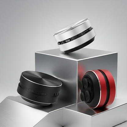 Three circular electronic devices in black, silver, and red on a reflective surface with a gray background.